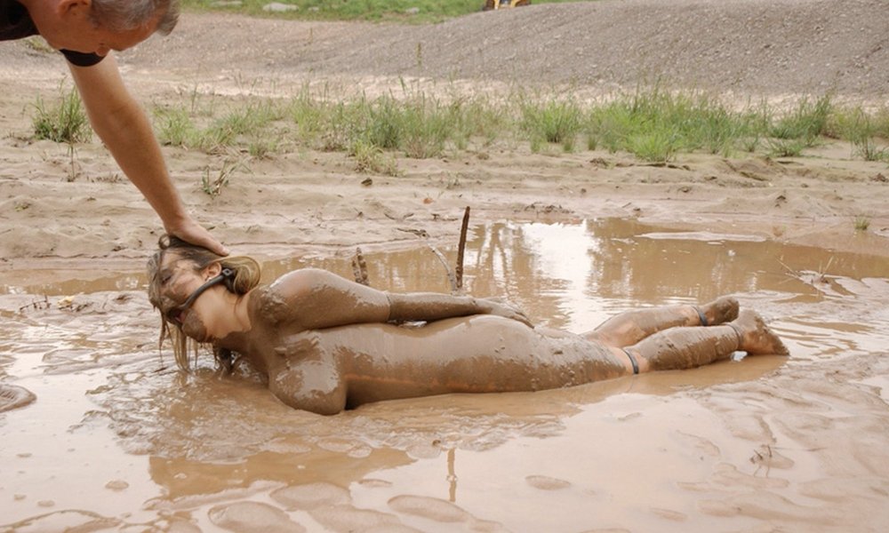 Naked women bathe in the mud