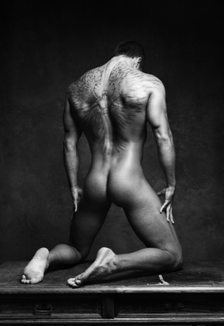 Beautiful naked man sits