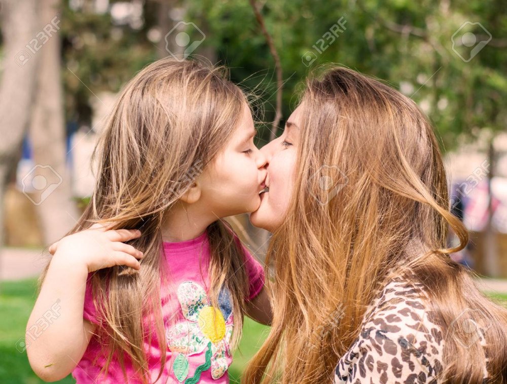 Mom and daughter French kiss