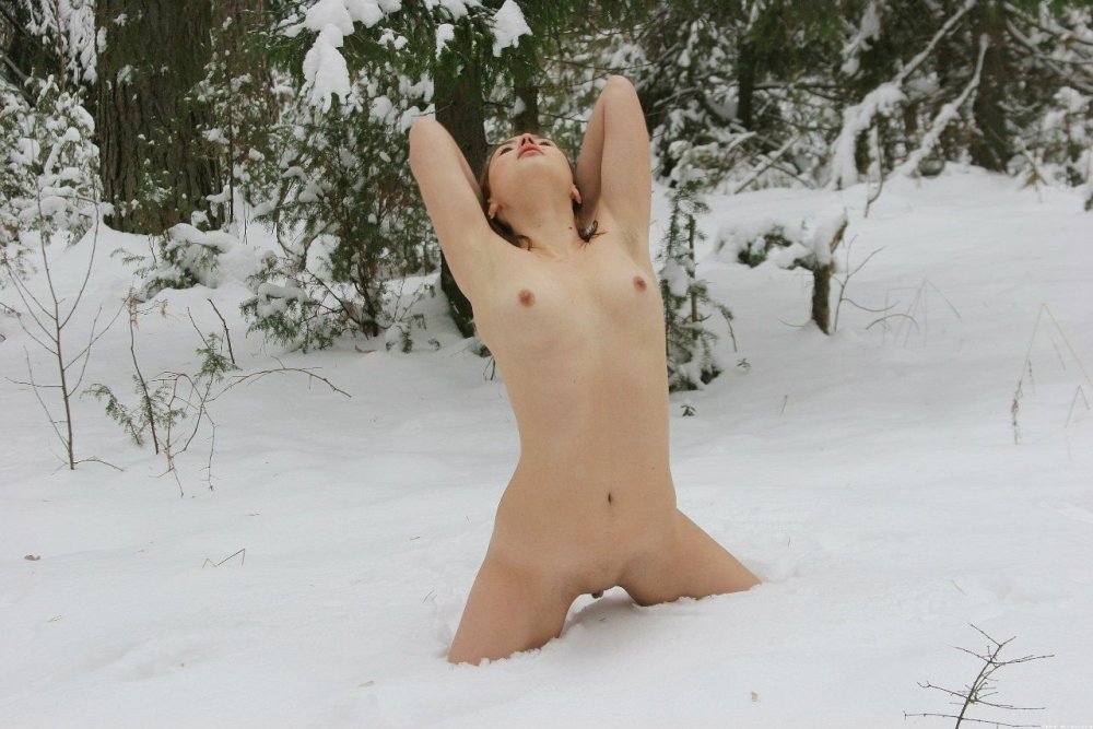 Naked woman lying in the snow